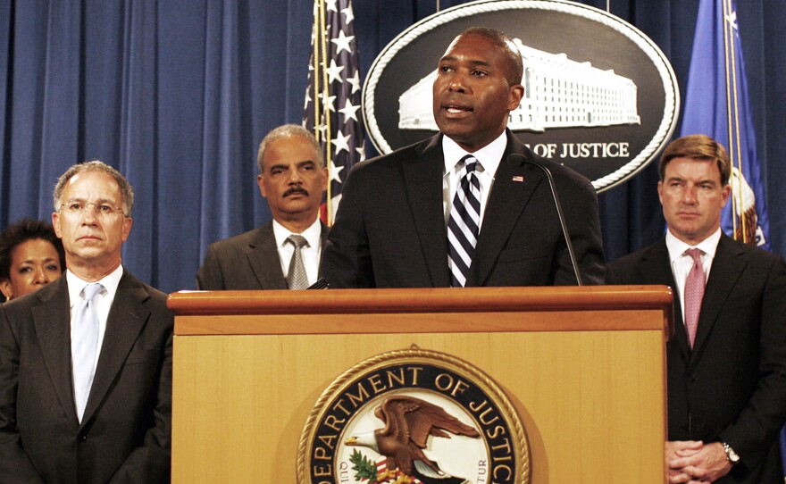 Associate Attorney General Tony West, at podium, speaks at the Justice Department in Washington on Aug. 21. West is preparing to announce he is leaving government for a job in the private sector.
