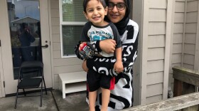 Sadia Kahn poses for a photo with her son Hashim outside their new apartment in University Village in this undated image. 
