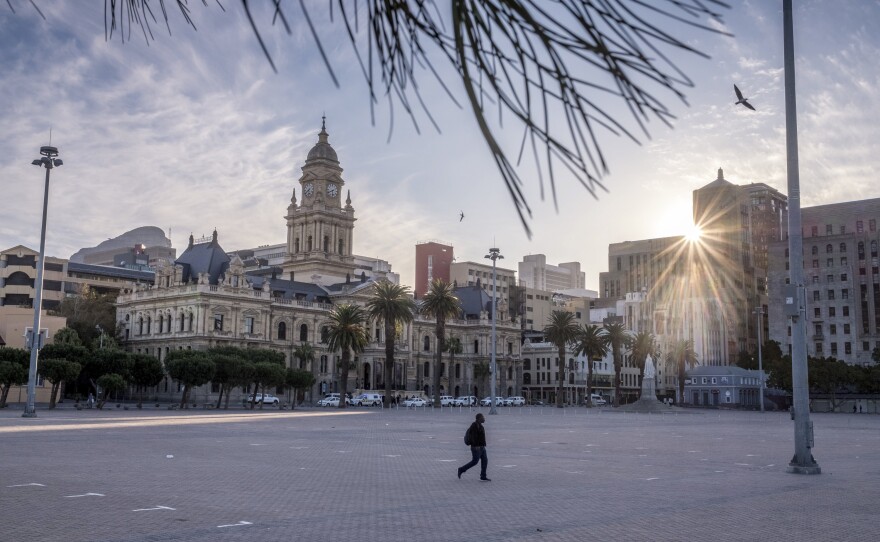 A man walks across a deserted square in central Cape Town, South Africa, two weeks into the country's coronavirus lockdown.