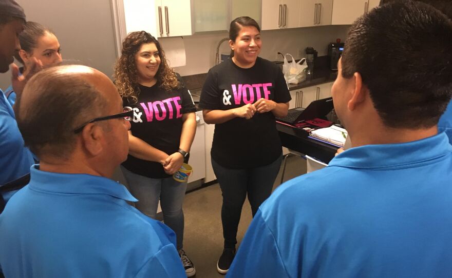Mid-City CAN Director of Civic Engagement Griselda Ramirez (left) addresses a circle of canvassers before the volunteers head out to reach voters, Nov. 5, 2018.