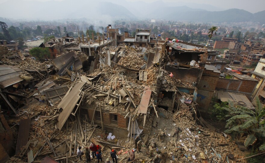 Rescue workers remove debris as they search for victims of earthquake in Bhaktapur, near Kathmandu, on Sunday.