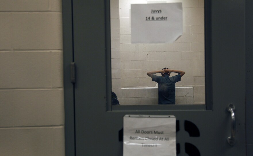 A young immigrant caught crossing the border illegally is housed inside the McAllen Border Patrol Station in McAllen, Texas, last month.