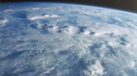 Water in the atmosphere traps heat, like glass in a greenhouse. When there's less water vapor in the atmosphere, less heat is trapped.
