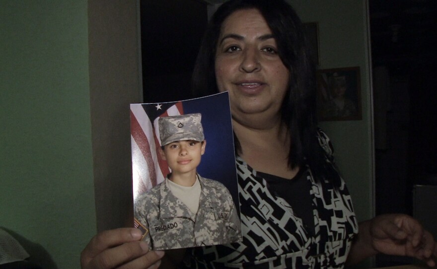 Rosa Maria Preciado holds up a photograph of her oldest daughter, who graduated high school in Luna County, New Mexico and now a medical assistant in the U.S. Military, Oct. 16, 2016.