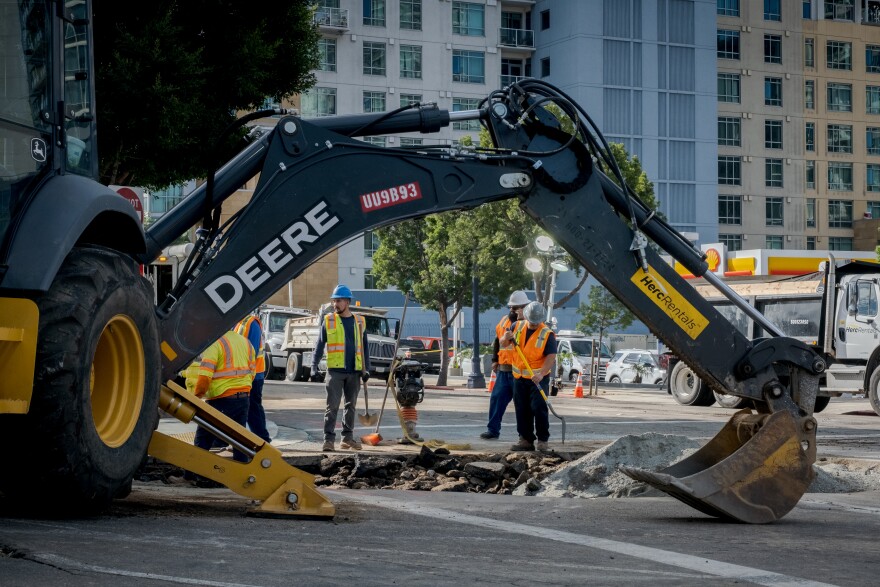 Repair crews work to fix a broken water main in downtown San Diego at the corner of 11th and A in Downtown San Diego, Calif. Nov. 22, 2021.