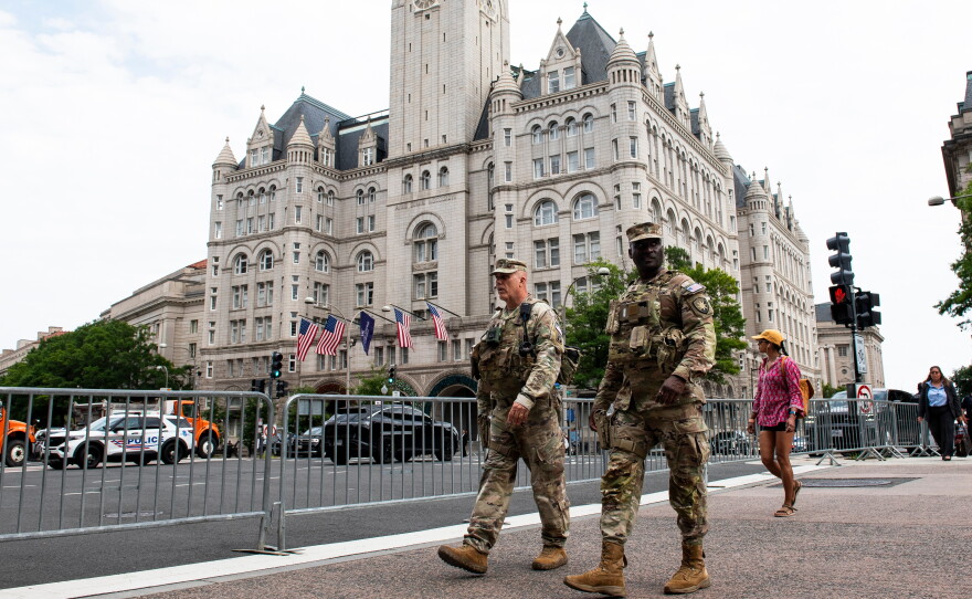 National Guard troops walk across the street from the Waldorf Astoria hotel where President Donald Trump attended the White House Correspondents' Association Dinner, in Washington, Friday, July 24, 2026. (AP Photo/Cliff Owen)