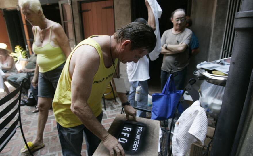 Residents of the Faubourg Marigny neighborhood of New Orleans printed T-shirts during a community meeting on Sept. 9, 2005. The neighborhood organized a cleanup effort even as mandatory evacuation of the city was under way. Refusing to obey the order to evacuate, many residents remained in their houses.
