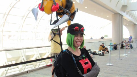 Cathy Yee poses as a Team Rocket thug from the video game–turned–anime "Pokémon," with her handmade Beedrill companion over her shoulder on July 25, 2025.