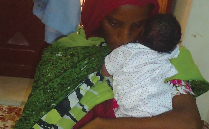Meriam Yahia Ibrahim Ishag, a Christian Sudanese woman sentenced to death, sits in her cell with her baby girl a day after she gave birth at a women's prison in Khartoum's twin city of Omdurman last month. A court ordered Ishag freed Monday.
