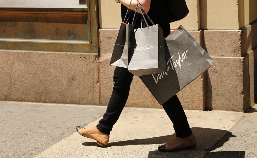 A woman walks out of Lord & Taylor's flagship store in Manhattan in June 2018, before the location was closed and the building was sold in 2019.