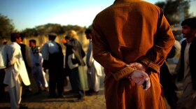 A man holds the keys to his car while yelling for customers to catch a ride with  him to Jalalabad in eastern Afghanistan and the border crossing at the  Khyber  Pass.