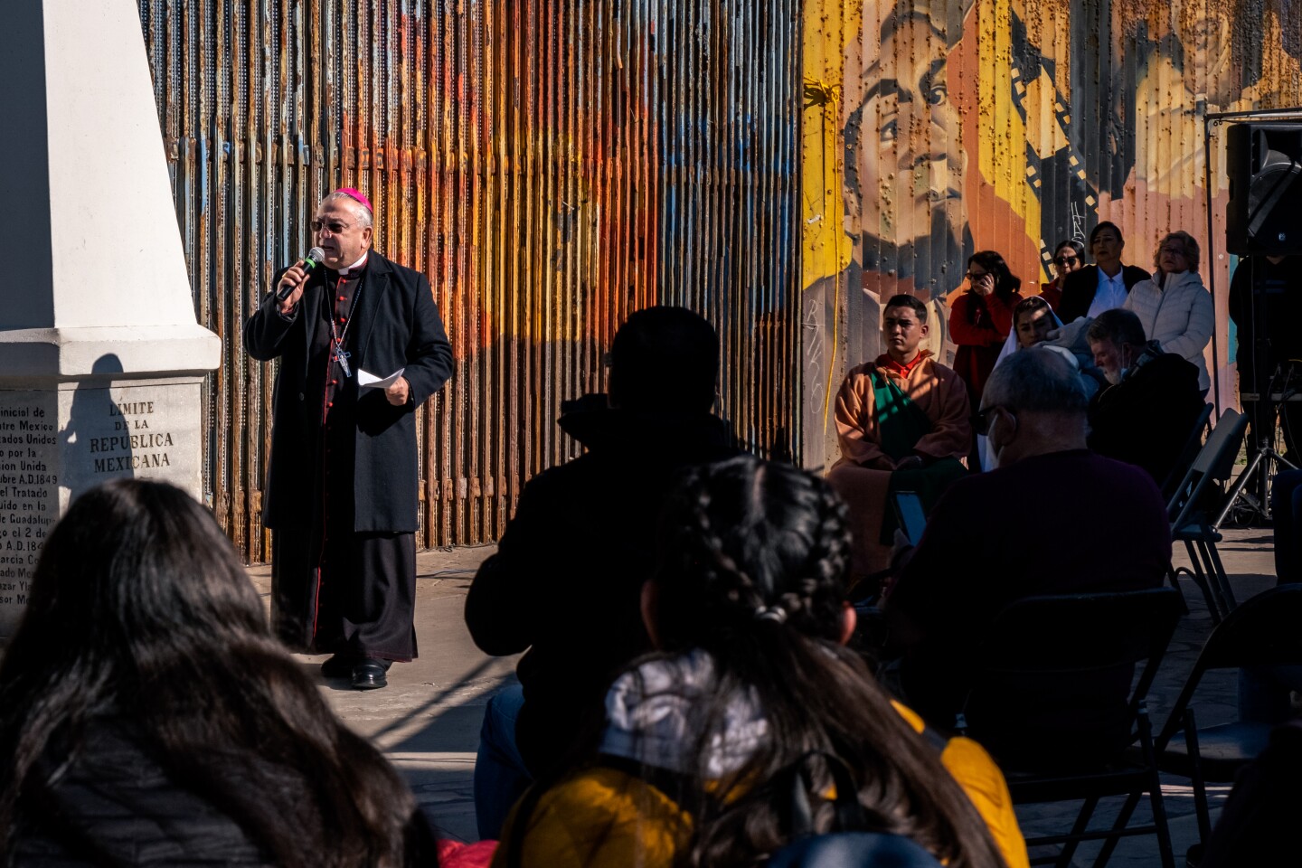 Archbishop of Tijuana Francisco Moreno Barrón stands in front of the border wall separating the United States and Mexico during the 29th annual La Posada Sin Fronteras or Without Borders. Tijuana, Dec. 10, 2022.