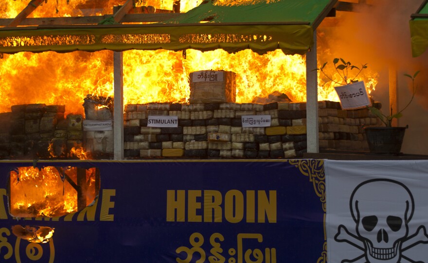 Smokes and flames billow from burning narcotic drugs during a destruction ceremony of seized narcotic drugs in outskirts of Yangon, Myanmar on June 26, 2018.