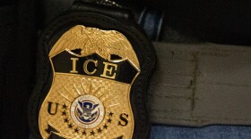 FILE - A federal agent wears an Immigration and Customs Enforcement badge in New York, June 10, 2025.