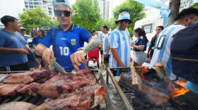 Matias Videla, of Dallas, a supporter of Argentina, checks meat on his grill during a rally ahead of his team's World Cup Group J soccer match against Austria, Sunday, June 21, 2026, in Dallas.