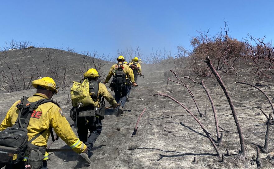 Firefighters patrol the fireline and mop up hot spots at the Chapparral Fire, which strandles San Diego and Riverside counties. Aug. 31, 2021.
