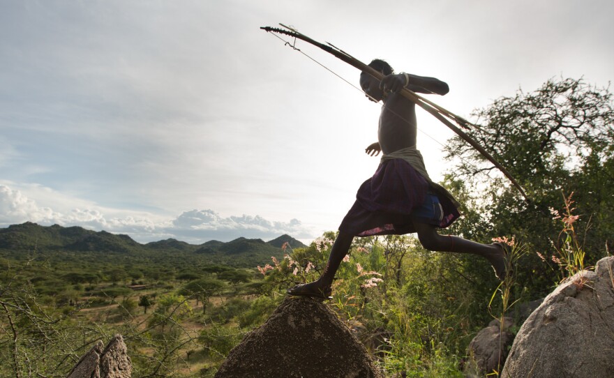 A Hadza man on a hunt, with his bow and arrow.