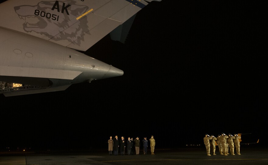 President Trump and military personnel salute during a dignified transfer ceremony at Dover Air Force Base for fallen U.S. Army sergeants Javier J. Gutierrez and Antonio R. Rodriguez.