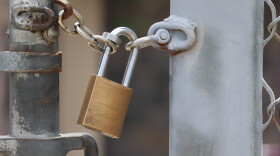 A padlock secures a fence at a school in Santee on Wednesday, Aug. 5, 2026.