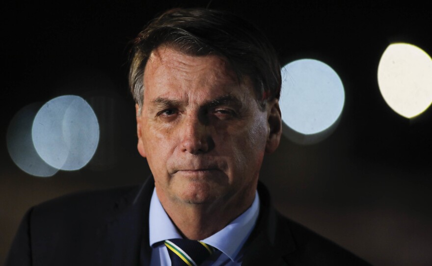Brazil's President Jair Bolsonaro speaks to reporters in Brasilia on Thursday.