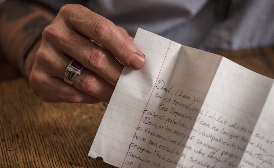 Toombs holds his son's suicide note. Hours before his death, Sgt. Toombs recorded a video in which he said of the VA center: "When I asked for help, they opened up a Pandora's box inside of me and just kicked me out the door."