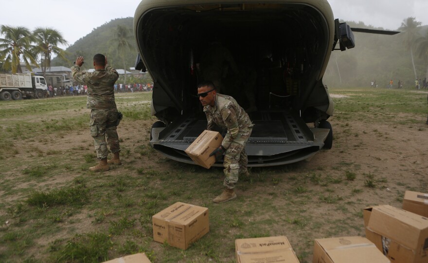 A U.S. Army helicopter unit unloaded boxes of humanitarian aid to the remote town of Baradères, Haiti, located northeast of Les Cayes on Wednesday.
