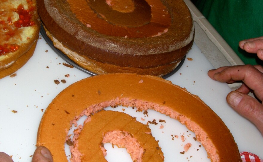 The checkerboard pattern is created by cutting pink and chocolate layers into concentric rings and reassembled to look like a bull's-eye.