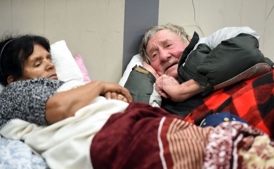 Evacuees Steve Allen and Alicia Castro lie on cots at the Placer County Fairgrounds evacuation center in Roseville, Calif. They are two of the almost 200,000 people under evacuation orders in Northern California Monday after a threat of catastrophic failure at part of the Oroville Dam.