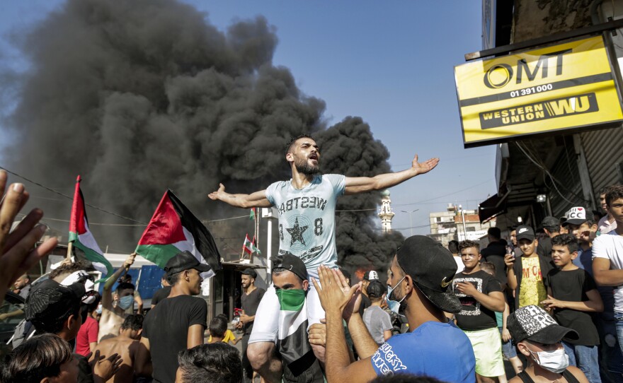 Protesters block the main road outside the Palestinian refugee camp of Burj al-Barajneh, south of the Lebanese capital Beirut, on July 16. The protests are against Lebanese government decision to restrict Palestinians' work opportunities.