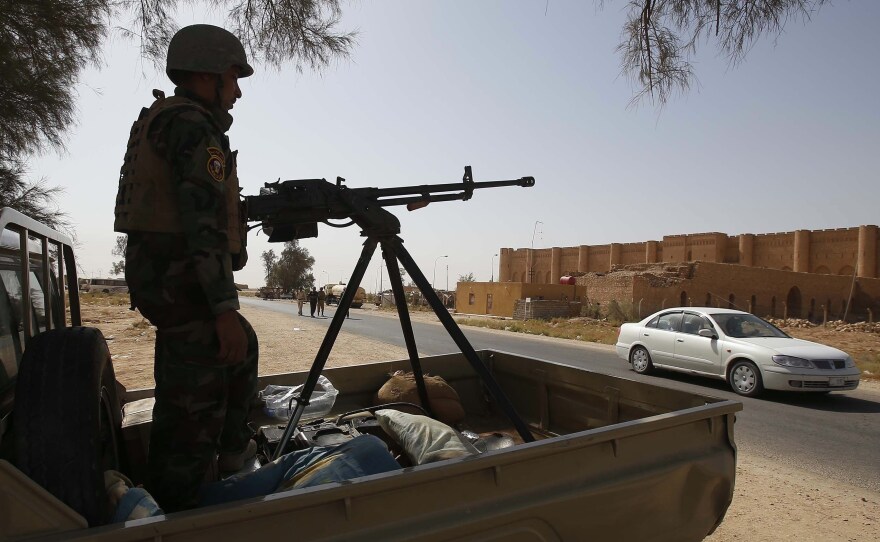 An Iraqi soldier monitors a street west of the shrine city of Karbala, in central Iraq on Sunday.