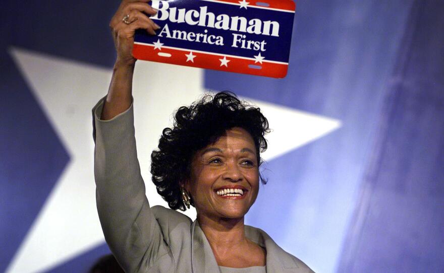 Reform Party vice presidential candidate Ezola Foster holds up an "America First" sign after her nomination acceptance speech in August 2000. Foster, the first African American woman to be nominated for the position, was running on the Reform ticket with presidential candidate Pat Buchanan.