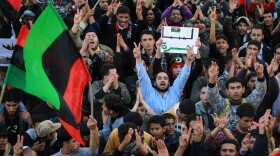 Rebel supporters cheer during a celebratory rally after the United Nations approved a no fly zone over the country on March 18, 2011 in Tobruk, Libya. Libya declared an immediate cease-fire after the UN vote but reports indicate that Moammar Gadhafi's forces were still shelling two cities.