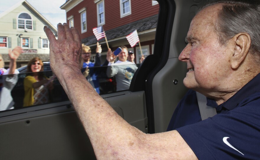 In this May 20 photo provided by the office of George H.W. Bush, the former president waves to supporters as his motorcade arrives in Kennebunkport, Maine. A Bush spokesman said the nation's 41st president was eager to get to Maine after enduring his wife's death and then being hospitalized shortly after that with a blood infection.