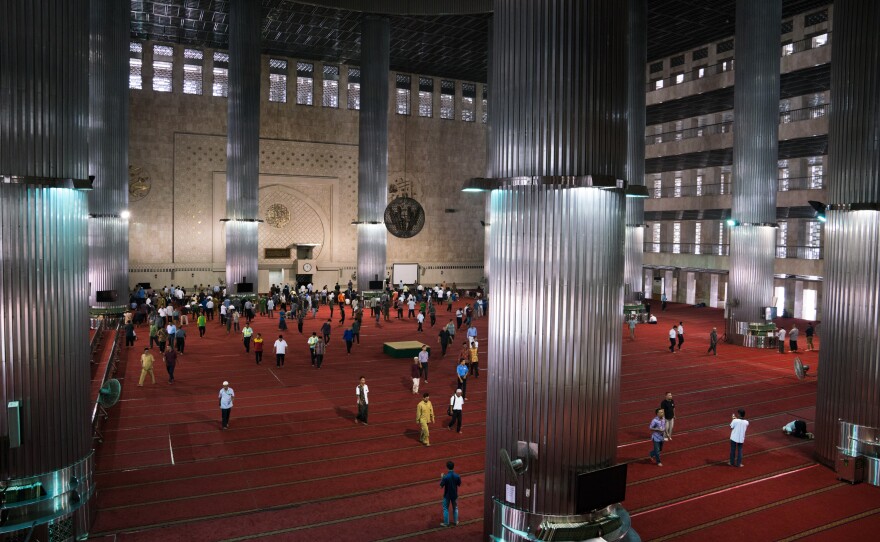 People leave the Istiqlal mosque after prayers. Istiqlal is the national mosque of Indonesia and was built in the 1970s to commemorate the country's independence.