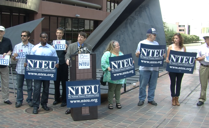 Federal employees from the National Treasury Employees Union call for an end to the October government shutdown at a press conference, Oct. 3, 2013.