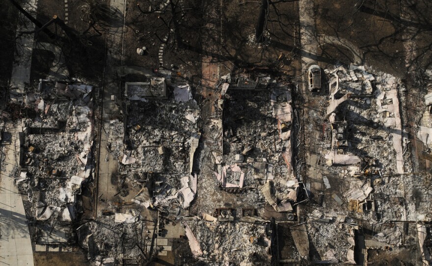 An aerial photo shows the charred homes of Louise Hamlin, center left, and Chris Wilson, center right, after the Eaton Fire in Altadena, Calif., Thursday, Jan. 30, 2025.