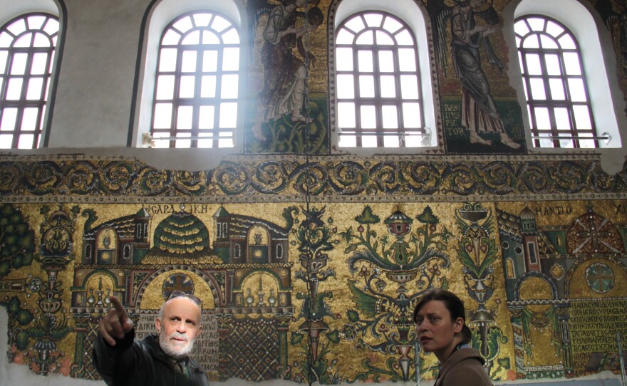 Engineer Imad Nassar, a Palestinian Christian from Bethlehem and technical manager for the Nativity Church restoration project, guides a journalist in the church.