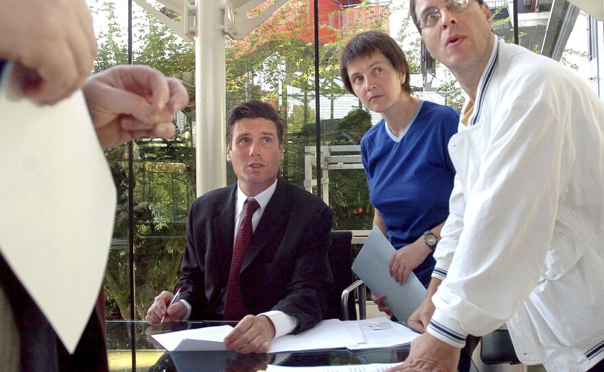 British environmental activists Helen Steel (second right) and David Morris (right) discuss with their lawyer, Keir Starmer (seated), as they wait for the beginning of their hearing at the European Court for Human Rights on Sept. 7, 2004, in Strasbourg, eastern France.