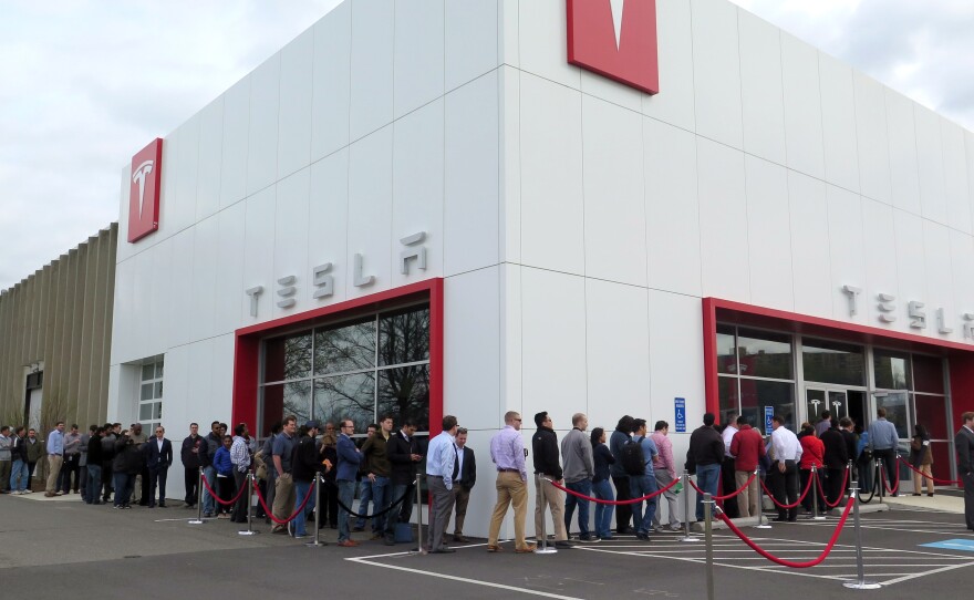 Customers lined up at a Tesla store on Thursday to put in down payments for the new Tesla Model 3 in the Washington, D.C., suburb of Tysons Corner, Va.