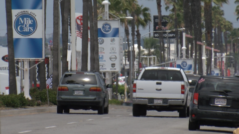 Cars drive along the National City Mile of Cars auto mall, May 28, 2020.