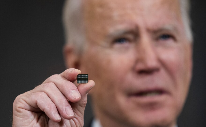 President Biden holds a chip during remarks before signing an executive order on the economy on Feb. 24. The Biden administration is taking steps to try to improve the supply of semiconductors in the United States.