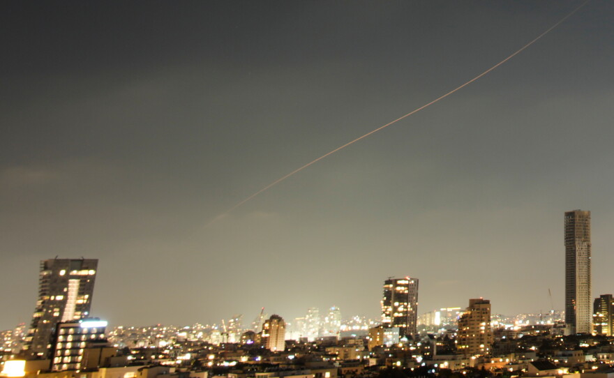 A projectile streaks through the sky over central Israel during an Iranian missile attack, Sunday, June 7, 2026.