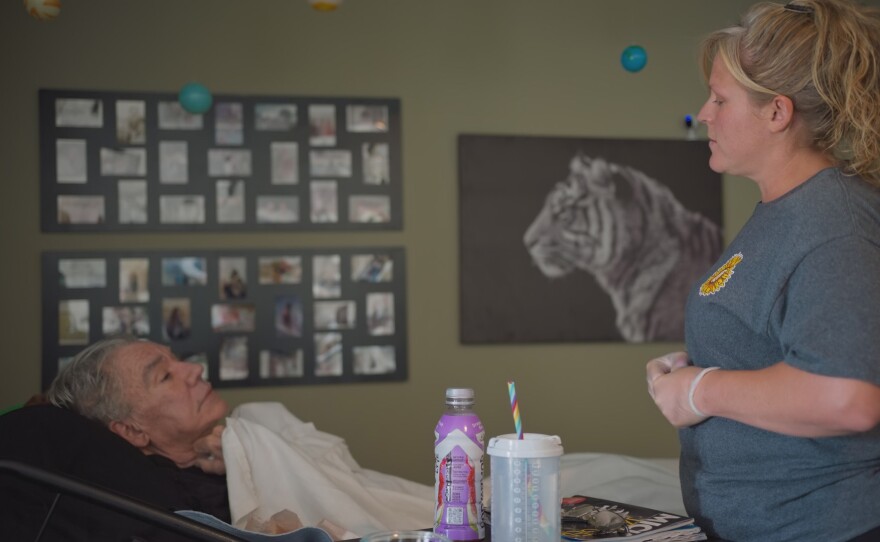 Tracy Eacret with her father, John, to whom she is providing end-of-life care at her Colorado home. Both are featured in "Caregiving."