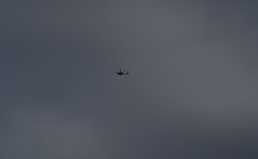 An Israeli military helicopter flies above the highway rest stop at Beit Kama Junction.