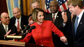 Speaker of the House Nancy Pelosi grabs hold of Rep. Patrick Kennedy's hand during a press conference following House passage of the Democrats' health care bill on Nov. 7.