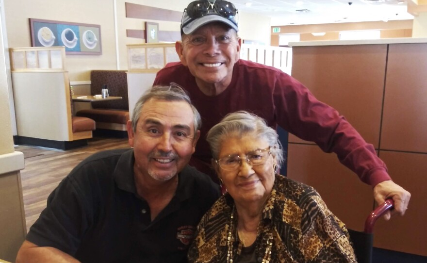 David (seated on the left) and Sky Gonzalez and their mother, Eva, at a restaurant before the pandemic. Since the quarantine restrictions, Eva has become more agitated, and calls from her sons are creating more stress for her.