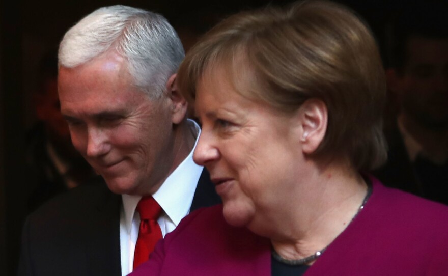 German Chancellor Angela Merkel and U.S. Vice President Pence talk at the Munich Security Conference on Saturday.