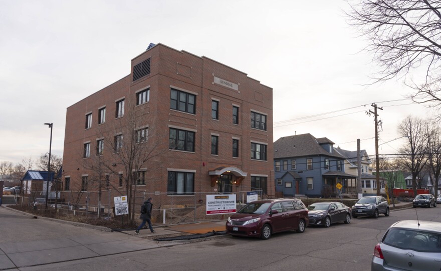 The Sundial is located between neighborhood houses and a larger mixed-use building along Nicollet Avenue.