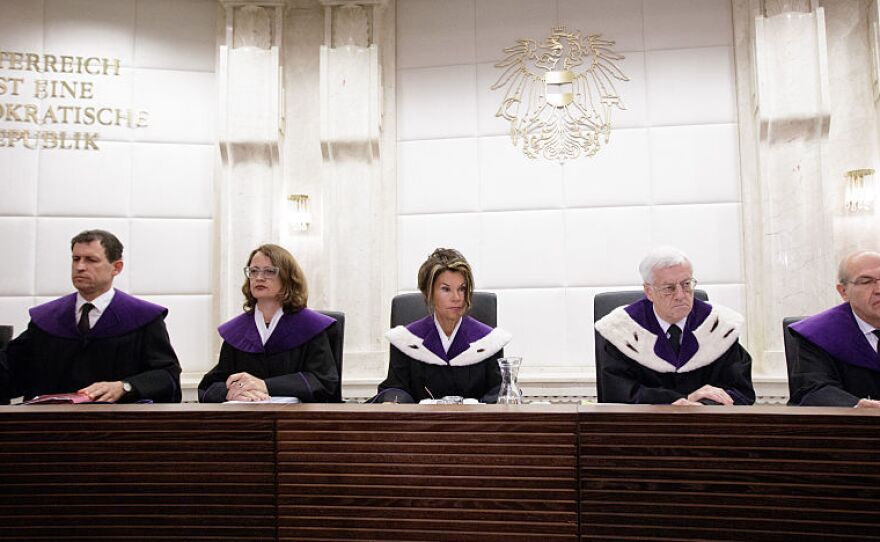 Members of Austria's Constitutional Court appear ahead of a public hearing earlier this month to consider annulling the result of the country's May runoff.