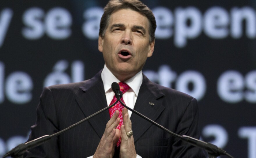 <p>Texas Gov. Rick Perry prays at The Response, his call to prayer for a nation in crisis, on Aug. 6 in Houston. The event was organized, in part, by members of the New Apostolic Reformation.</p>